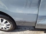 a close up of a car ' s tire on the side of the road
