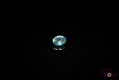 an image of a blue diamond in the dark with a black background