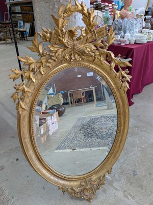a mirror that is sitting on the ground in front of a table