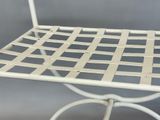 an image of a white metal chair with a woven seat