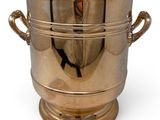 a large brass ice bucket with handles on a white background