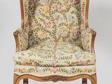 a chair with a floral upholstered back and a floral upholstered back