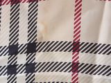 the fabric is white and black with a red and white checkered pattern