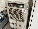 a small air conditioner that is sitting in the corner of a room