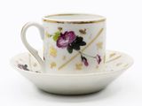 a cup and saucer with a floral design on it
