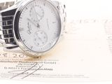 a watch that is sitting on top of a piece of paper