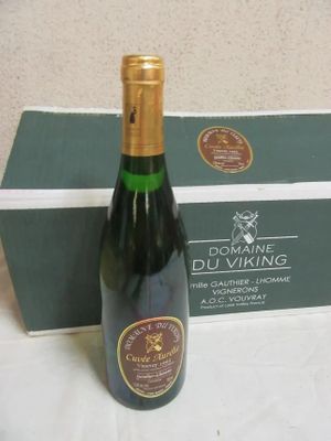 a bottle of wine sitting next to a box of wine