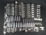 a lot of spoons and silverware on the table