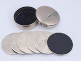 six different types of coins in a metal container on a white surface