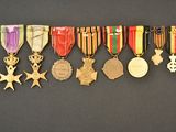 an assortment of medals and medals are displayed on a black surface