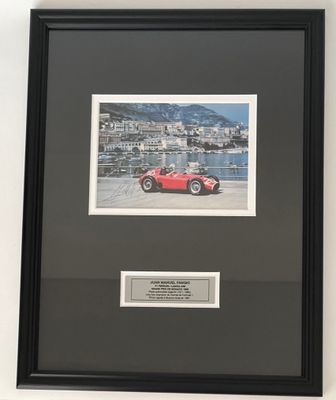 framed photograph of a red sports car in front of a body of water
