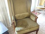 a green chair in the corner of a living room