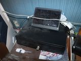 a laptop sitting on top of a suitcase on a table