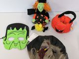 three halloween masks on a table with a bag