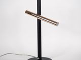 a black table lamp with a metal pole on top of it
