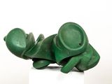 a green sculpture of a frog on a white pedestal