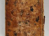 an old book sitting on top of a white table covered in dirt