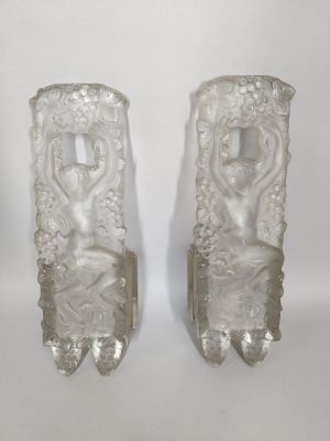 pair of clear glass vases with figures on them on a white background
