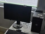 a desk with a computer monitor and keyboard on it