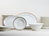 a lot of plates and bowls on the table