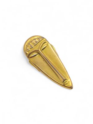 a close up of a gold pin on a white background