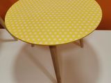 yellow and white polka dot round table with wooden legs