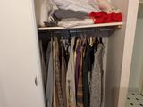 une armoire avec beaucoup de vêtements suspendus dedans