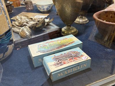 une collection d'argenterie exposée sur une table dans une vitrine