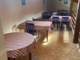 a room with tables and chairs in it with a skylight