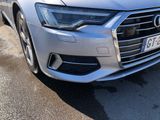 the front end of a silver audi parked in a parking lot