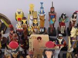a lot of figurines that are sitting on a chess board