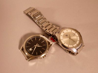 two watches sitting next to each other on a table