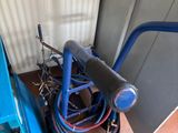 a blue machine that is sitting next to a wall