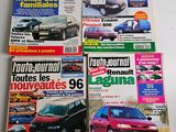 four magazines of different cars on display on a white surface