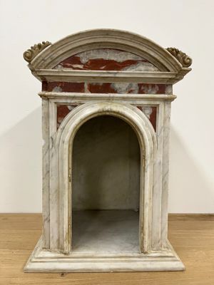 an image of a small dog house made of marble on a wooden floor