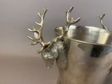 a silver cup with a deer head sticking out of it