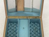 a small wooden box with a glass lid on a white surface