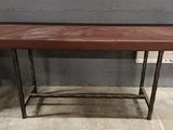 a small table with a wooden top and metal legs