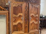 a large wooden cabinet with a mirror on top of it