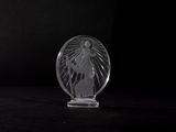 an image of a clear glass sculpture of a woman on a black background