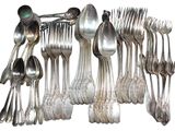a lot of silver spoons and spoons on the table