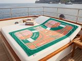 a bed on the deck of a boat with a map on it