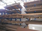 many shelves in the room that are full of wood