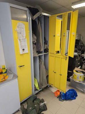 a yellow locker in the corner of a room with yellow doors
