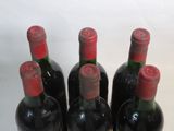 four bottles of wine are lined up in a row