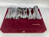 a red box with a bunch of silver spoons on it