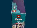 a box of lego friends figures sitting on a table