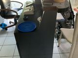a desk with a chair and a vase on top of it