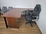a desk with a chair and a computer on it