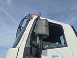 a white truck with a blue logo on the side of it